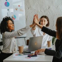 group of women high-fiving at a digital marketing agency